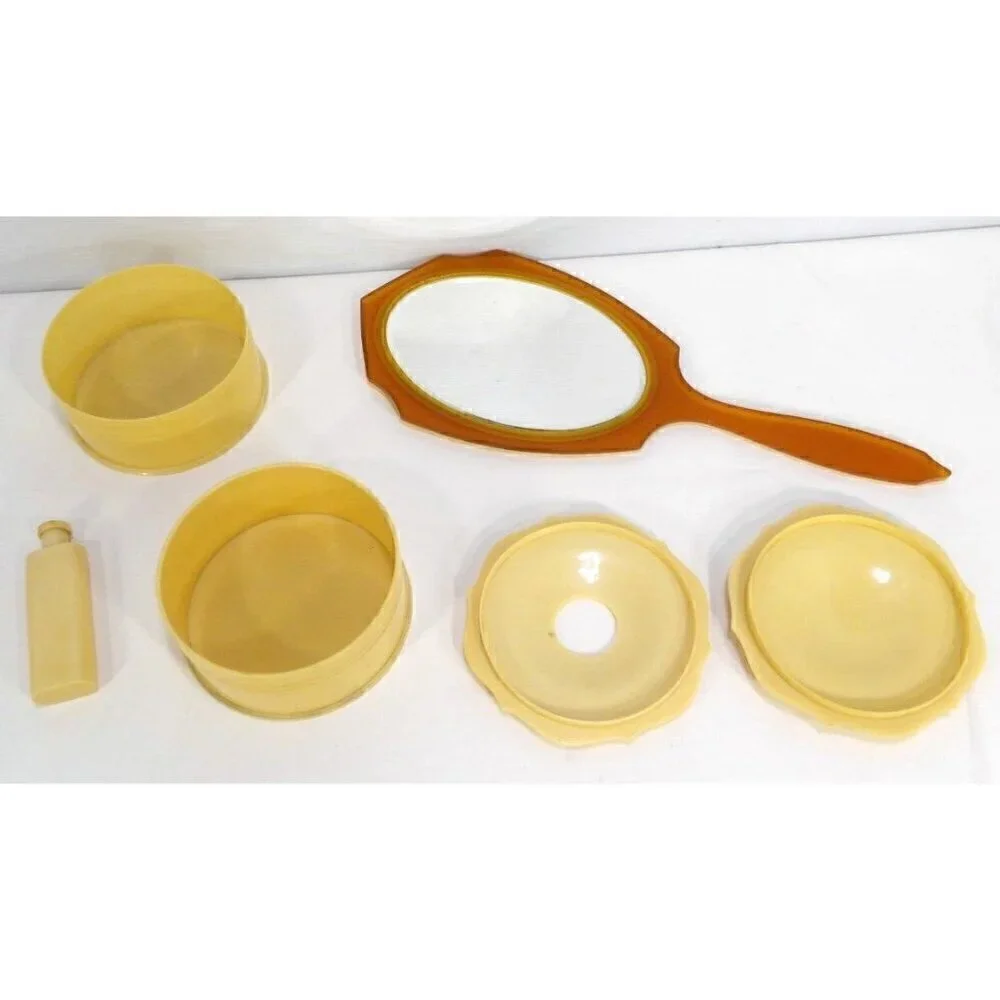 Beige celluloid hand mirror with round box, hair saver box & small bottle 1930's
